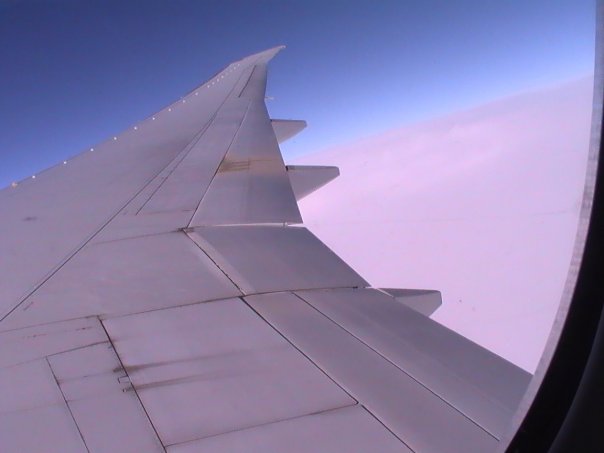 Boeing wing. Flying over the clouds